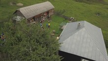 Aerial View Of Two Houses In Colibita, Romania During Tura Cu Copaci, A Cycling Race, With Bikers Resting.