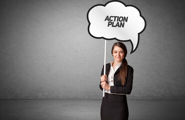 Young business person in casual holding road sign with ACTION PLAN inscription, new business idea concept