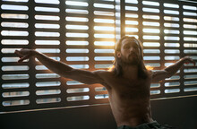 A Man With An Upper Body Without Clothes Posing Like Jesus