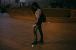 © Demetr White/Stocksy - girl stands on the street and catches light from the streetlights in her hands