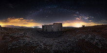 Wide Angle Ancient Roman Theater Of Acinipo City In Remote Landscape With Colorful Sunset Sky On Background
