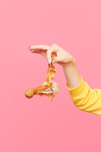 Woman dangles bitten fried chicken drumstick
