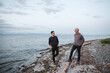 © Rob and Julia Campbell/Stocksy - Father and grown son talking together on the beach.