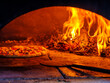 © ALAN SHAPIRO/Stocksy - wood fired pizza in oven