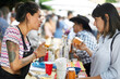 © Per Swantesson/Stocksy - Female seller selling craft drink to interested customer