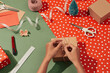 © Maki Company Limited/Stocksy - Woman's hands wrapping Christmas gift.