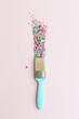 © Ruth Black/Stocksy - Paintbrush and colorful cake sprinkles