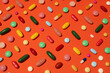 © Pixel Stories/Stocksy - Pills against orange background