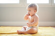 © Guille Faingold/Stocksy - Funny baby eating on floor