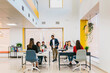 © MyMicrostock/Stocksy - Diverse people in open space office