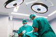 © MyMicrostock/Stocksy - Surgeons in the operating room