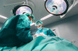 © MyMicrostock/Stocksy - Surgeons in the operating room