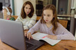 © Jakob Lagerstedt/Stocksy - Mother helping daughter with school work