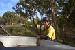 © Rowena Naylor Photography/Stocksy - Arborist leaning against work truck