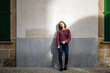 © Guille Faingold/Stocksy - Young woman leaning on wall