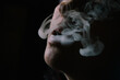 © Hakan & Sophie/Stocksy - Closeup of woman's mouth enjoying smoking