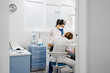 © Sergio Marcos/Stocksy - General view of Dentists with a patient from the door