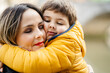 © Sergio Marcos/Stocksy - Mother and son hugging