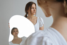 Portrait Of Twin Sisters With Reflection In The Mirror