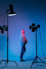 The Girl With Pink Hair In A Color Light At The Studio With Light Equipments
