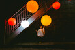© JImena Roquero/Stocksy - Scene of a kid under the stairs touching a big orange lamp