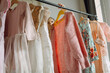 © Tanya Yatsenko/Stocksy - Girl choosing dresses on a clothing rack
