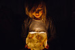 © Tanya Yatsenko/Stocksy - A girl with a hand made lamp in the dark