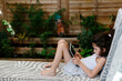 © JImena Roquero/Stocksy - Kid looking at a tablet in a terrace