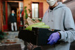 © JImena Roquero/Stocksy - Man delivering box of food