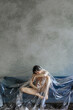 © Ivan Ozerov/Stocksy - concept photo. The girl is lying under a cellophane film on the sofa
