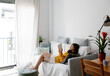 © JImena Roquero/Stocksy - Young woman at home reading