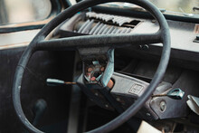 Closeup Of Broken Shabby Steering Wheel Inside Of Abandoned Retro Fashioned Car
