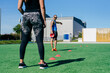 © Manuel Ruiz Alba/ADDICTIVE STOCK - Crop young athletic female performing agility exercise with training cones during fitness workout with personal trainer on sports ground