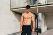 © Manuel Ruiz Alba/ADDICTIVE STOCK - Muscular shirtless male athlete standing resting after hard workout and looking down