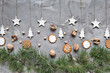 © Sofia Roncero/ADDICTIVE STOCK - Winter Christmas arrangement with various cookies and nuts placed with green spruce branches and handmade decorations on gray background