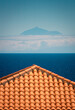 © Javier Martinez/ADDICTIVE STOCK - Building tile roof in a hill near ocean under blue clear sky