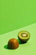 © Si And Si/ADDICTIVE STOCK - Half of delicious ripe kiwi fruit placed on green background in modern studio