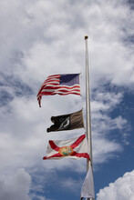 Flags Flying At Half Mast Including The IA POW Flag And The Florida State Flag