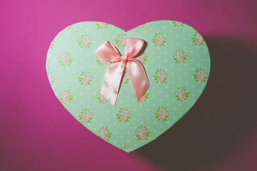 vintage gift box in the shape of a heart with a bow, holiday concept