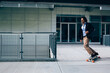 © Michela Ravasio/Stocksy - Young businessman going to work on a skateboard