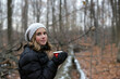 © ALICIA BOCK PHOTOGRAPHY/Stocksy - A Girl Enjoying A Cup Of Hot Chocolate In A Peaceful Forest