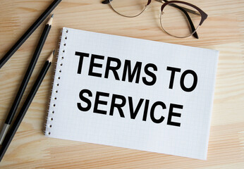 Leinwandbilder - The inscription on the card TERMS OF SERVICE, in the background are piled up.