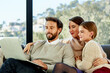 © ALTO IMAGES/Stocksy - Family Using Laptop On Sofa At Home