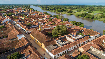 Wall Mural - Aerial view of the historic town Santa Cruz de Mompox in sunlight with river and green sourrounding, World Heritage