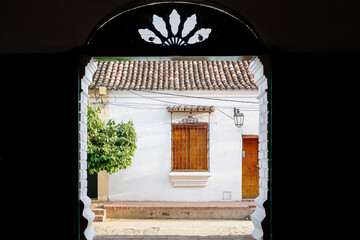 Wall Mural - Framed view to a typical historic white building with wooden window, Santa Cruz de Mompox, Colombia, World Heritage