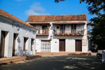 Wall Mural - Beautiful old white buildings in sunlight, trees in shadow, Santa Cruz de Mompox, Colombia, World Heritage