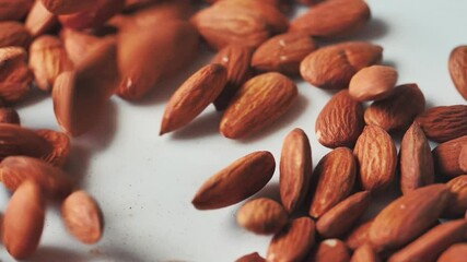 Wall Mural - Almonds rotation on the white background - falling -16