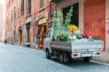 Old Truck On A Street In Italy Full Of Flowers