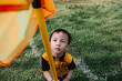 © Lawrence del Mundo/Stocksy - Little kid trying to figure out how to get the orange flag