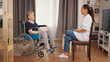 © DC Studio - Senior woman in wheelchair having a conversation with nurse. Old person retirement home, healthcare nursing, health support, social assistance, doctor and home service